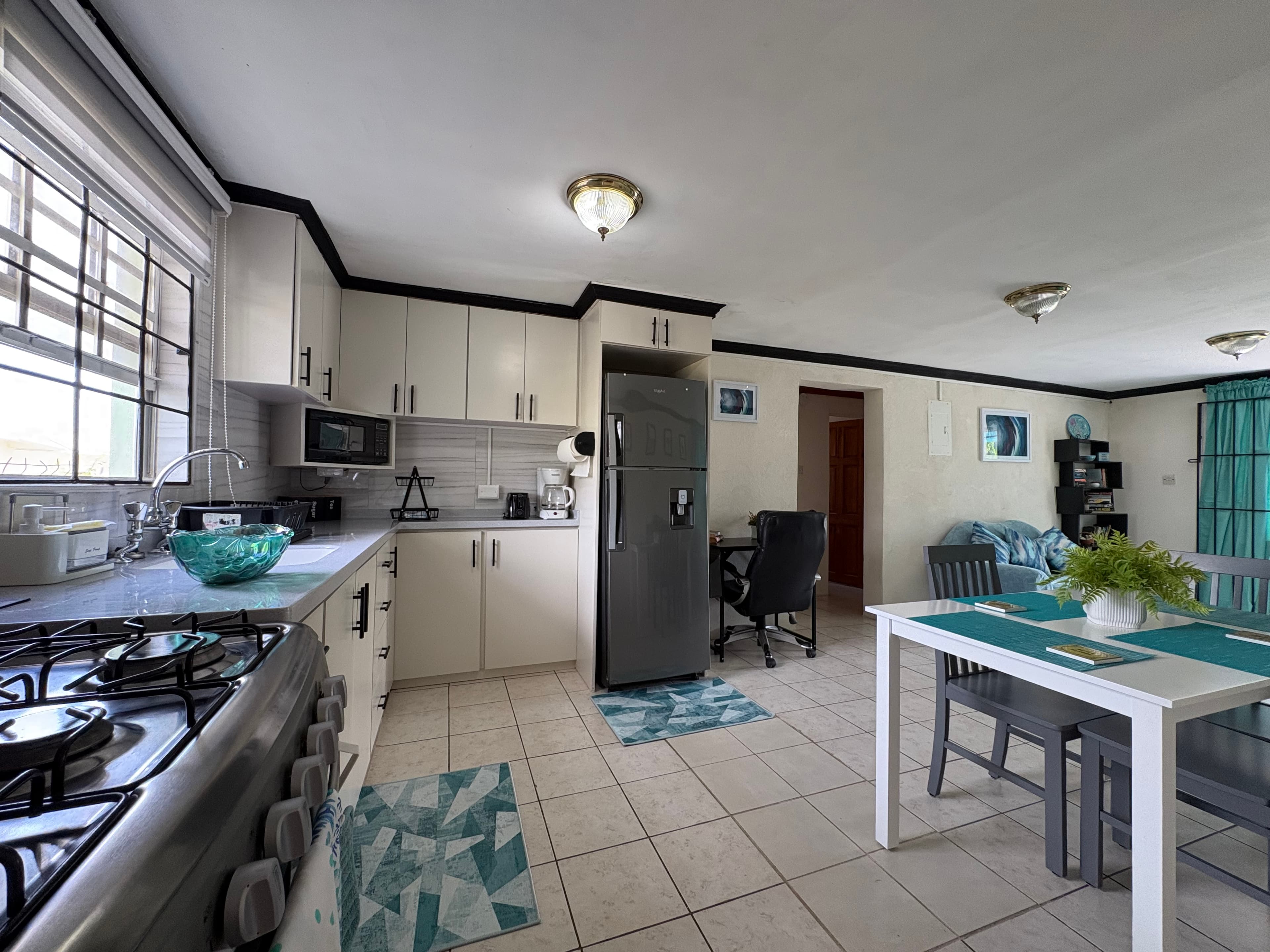 Bright open kitchen, dining, and living area inside the Garden Suite.